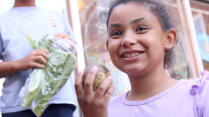 girl holds a turnip