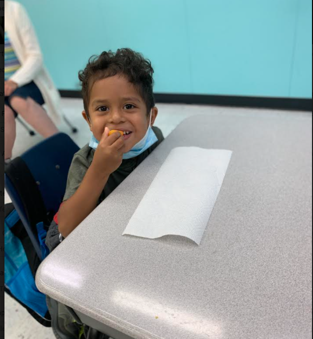 a child tries food in the classroom