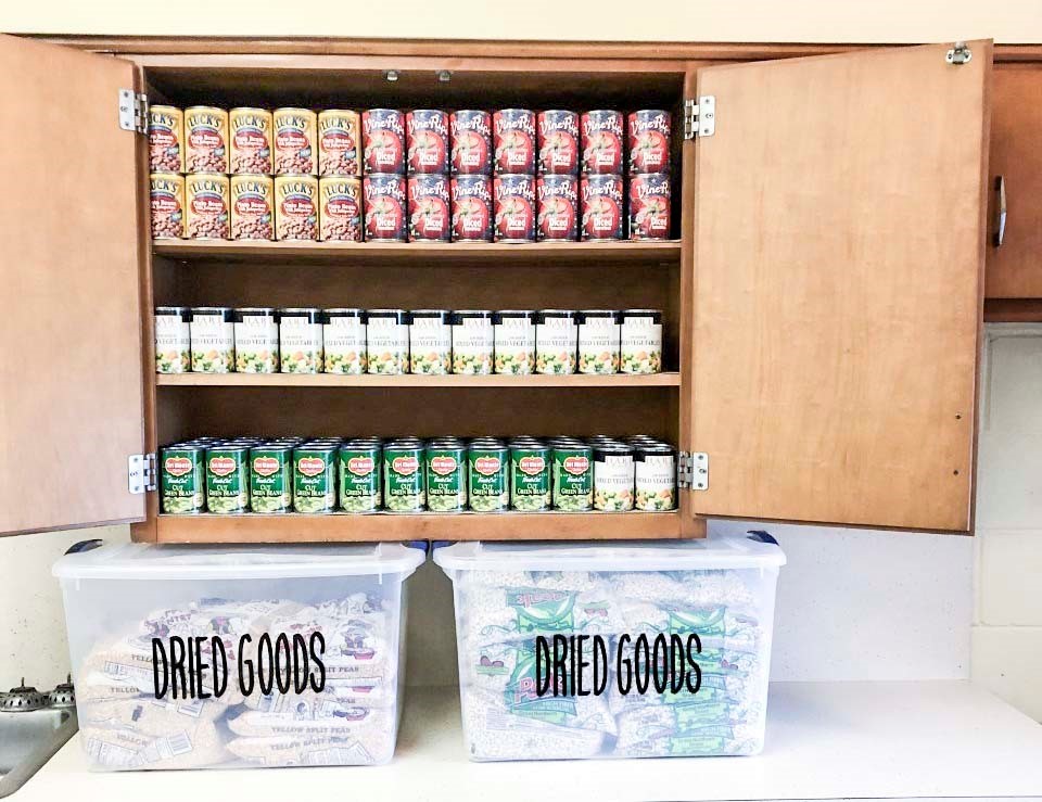 canned food displayed in a cabinet and dried goods are stored in bins