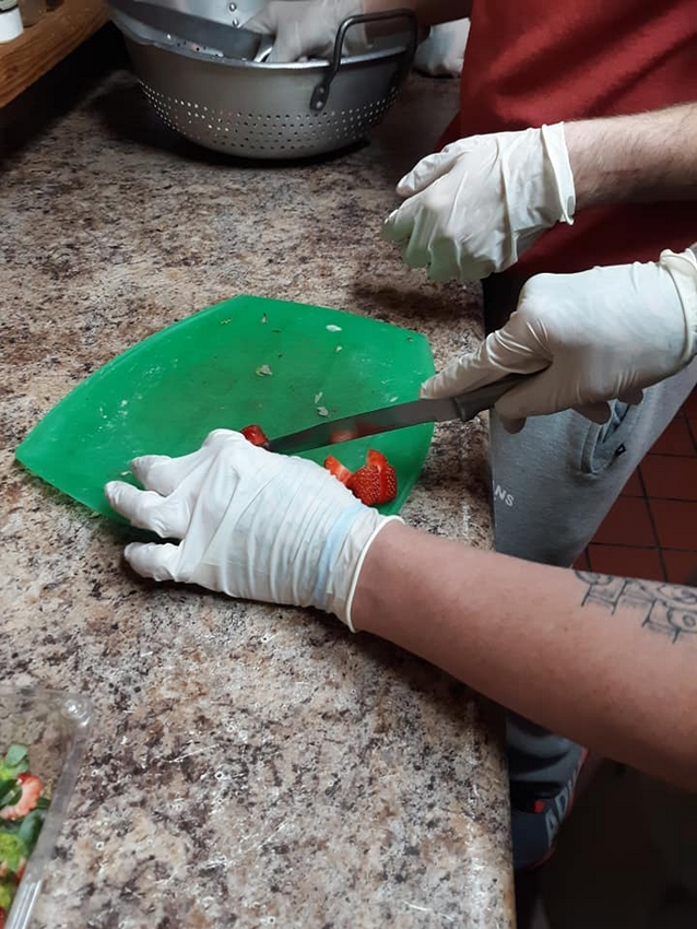 Slicing the harvested strawberries to use in smoothie