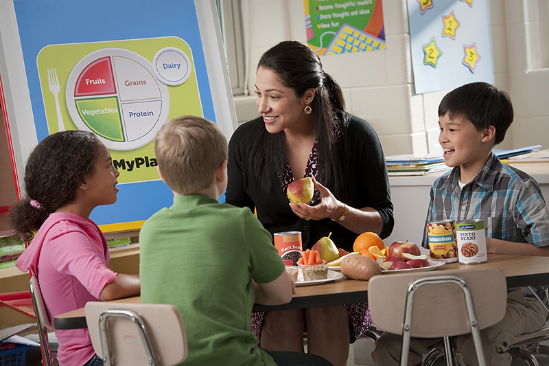 A nutrition educator teaches children about MyPlate SNAPEd
