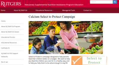 woman shopping with children in the produce section. select to protect logo in the corner