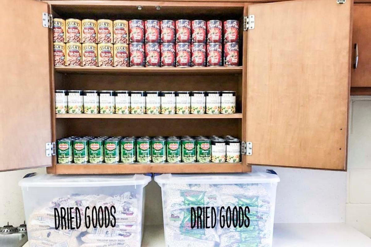 canned food displayed in a cabinet and dried goods are stored in bins