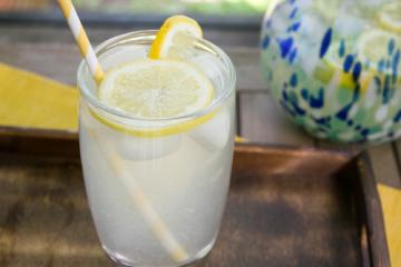 a glass of lemonade with a reusable straw in it