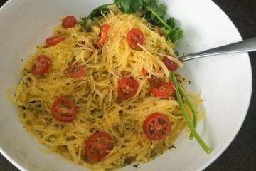 Spaghetti squash with cherry tomatoes in a white bowl