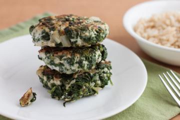 stack of spinach and meat cakes on a white plate