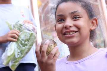girl holds a turnip