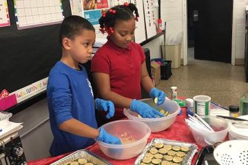 kids prepare zucchini bites in the classroom