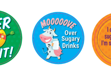 3 stickers: green background Super Fruit! with a lemon wearing a cape; blue background with a cartoon cow holding a glass of milk mooooove over sugary drinks; an orange background I don't need sugary drinks. I'm sweet enough already!