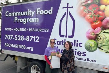Community Food Program truck with two employees smiling