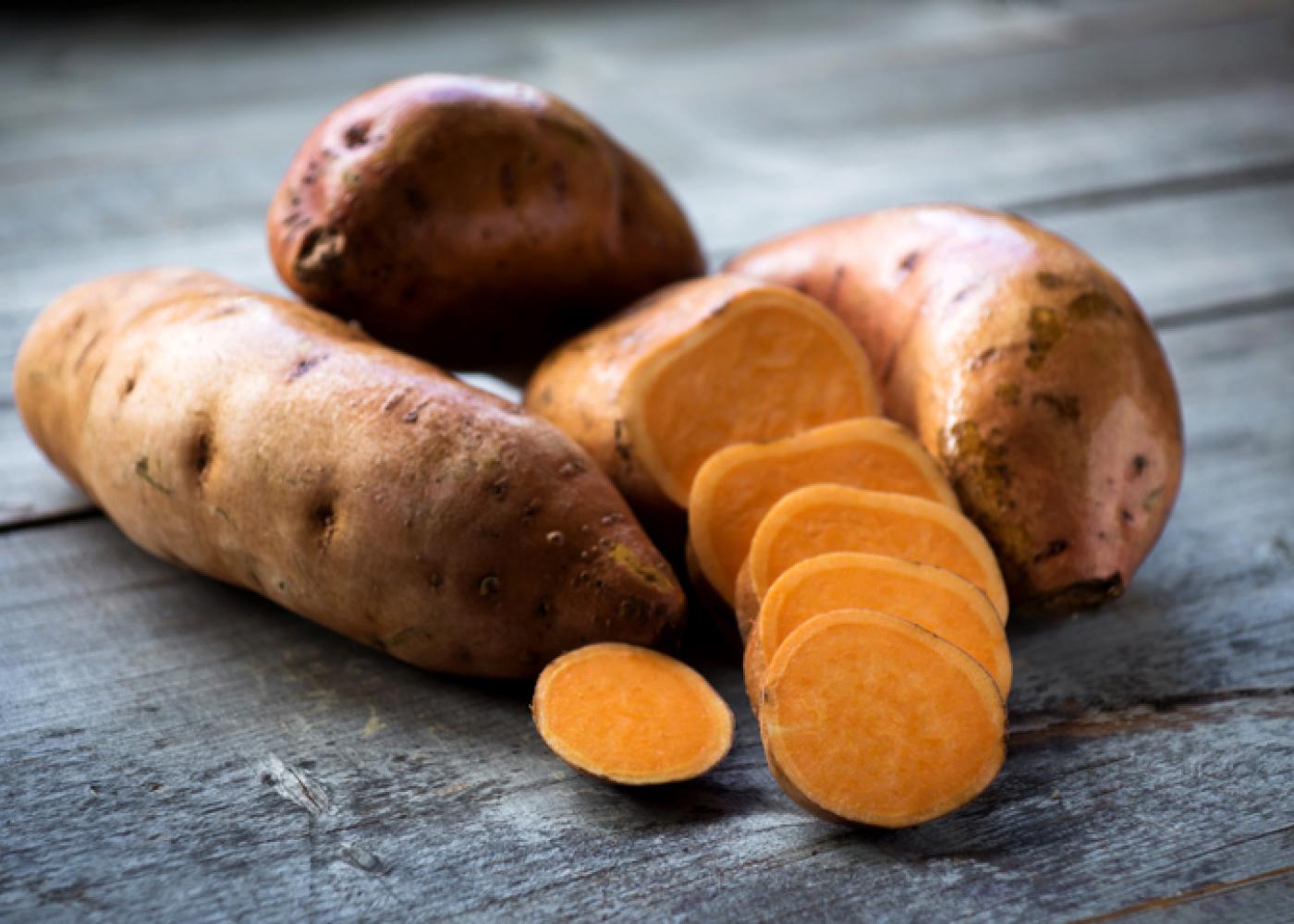 whole and sliced sweet potatoes