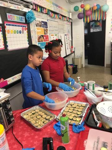 two children prepare zucchini bites 