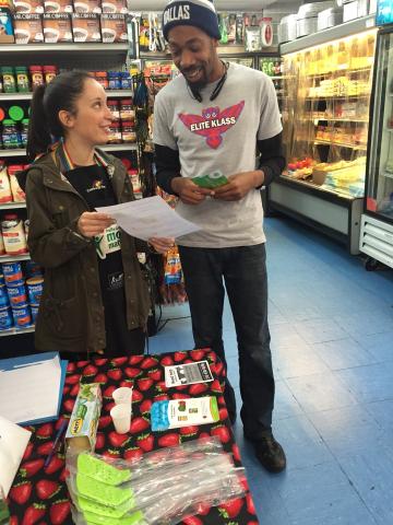 man talking to a nutrition educator in a grocery store