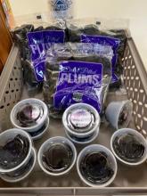 Dried plums in a bag and in small plastic containers