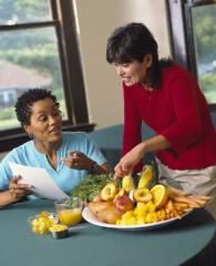 A nutrition educator talking about fruits and vegetables with an adult student